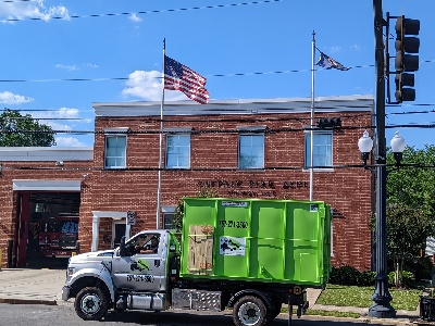 dumpster truck in front of suffolk fire department